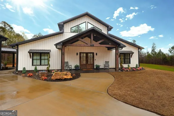 a view of a house with swimming pool and sitting area