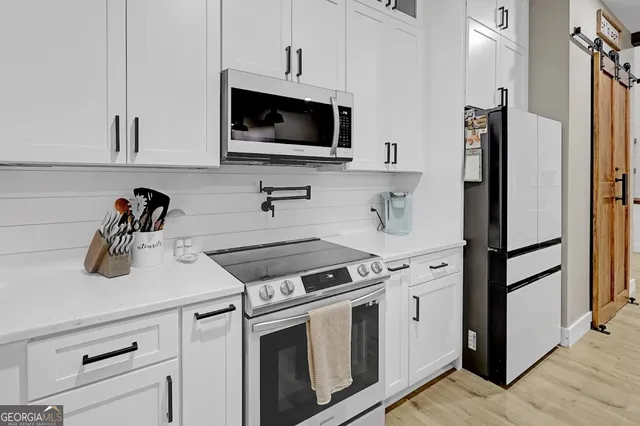 a bedroom with a large bed and a tv