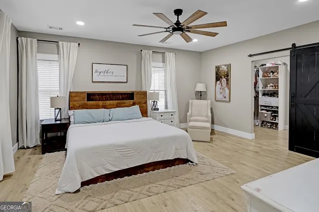 a bedroom with a large bed and a window