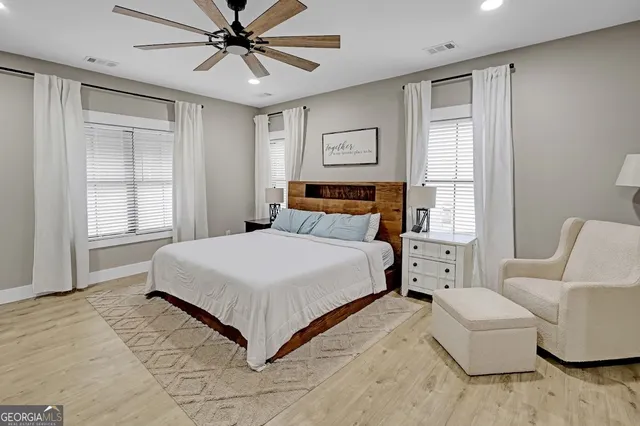 a bedroom with a large bed and a flat screen tv