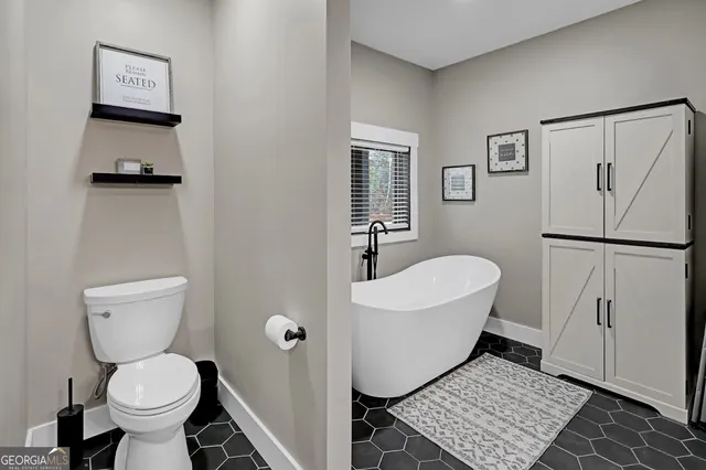 a spacious bathroom with a double vanity sink mirror and shower
