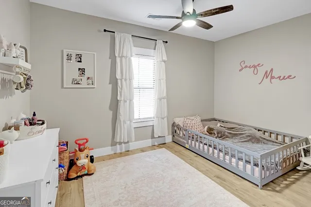 a bedroom with a bed and a large window