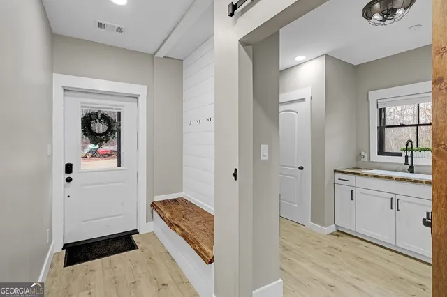 a utility room with sink dryer and washer