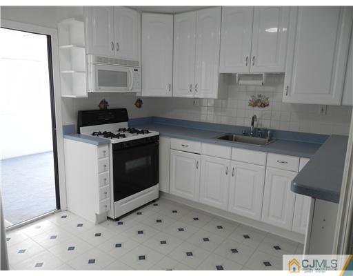 3 Sturgis Road Edison, NJ 08817 - Photo 4 of 17 a kitchen with granite countertop white cabinets and white appliances