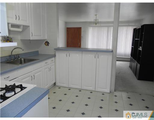 3 Sturgis Road Edison, NJ 08817 - Photo 5 of 17 a kitchen with granite countertop a sink a stove and cabinets
