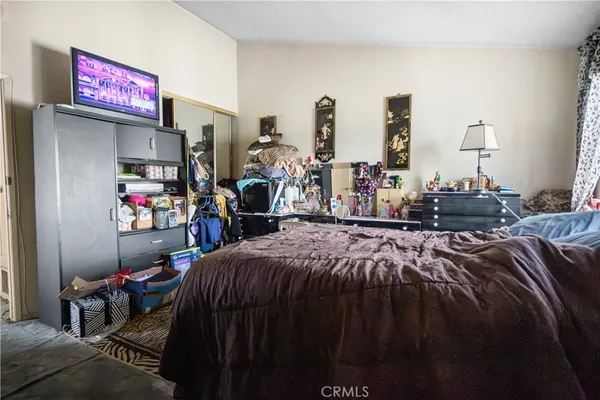 a bed room with a bed and a tv