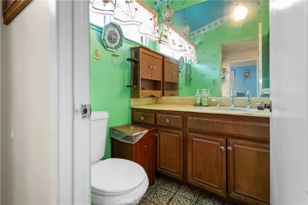 a bathroom with a toilet sink and mirror