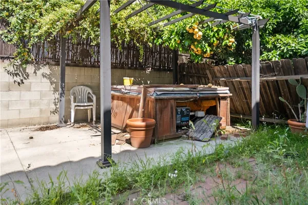 a view of a chairs and table in the back yard of the house