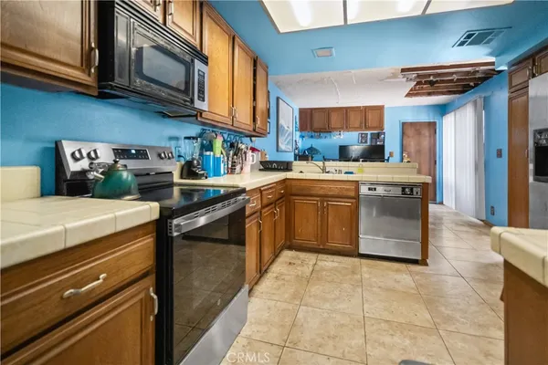 a kitchen with stainless steel appliances granite countertop a stove and a microwave