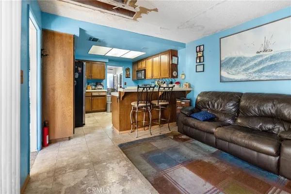 a living room with furniture and a dining table