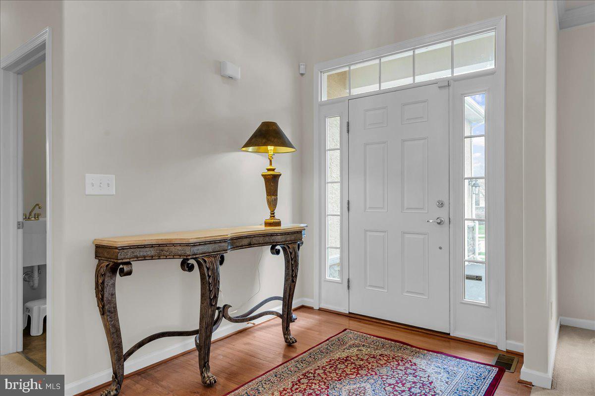 237 Crescent Road Landenberg, PA 19350 - Photo 11 of 46 a view of a hallway with wooden floor and staircase
