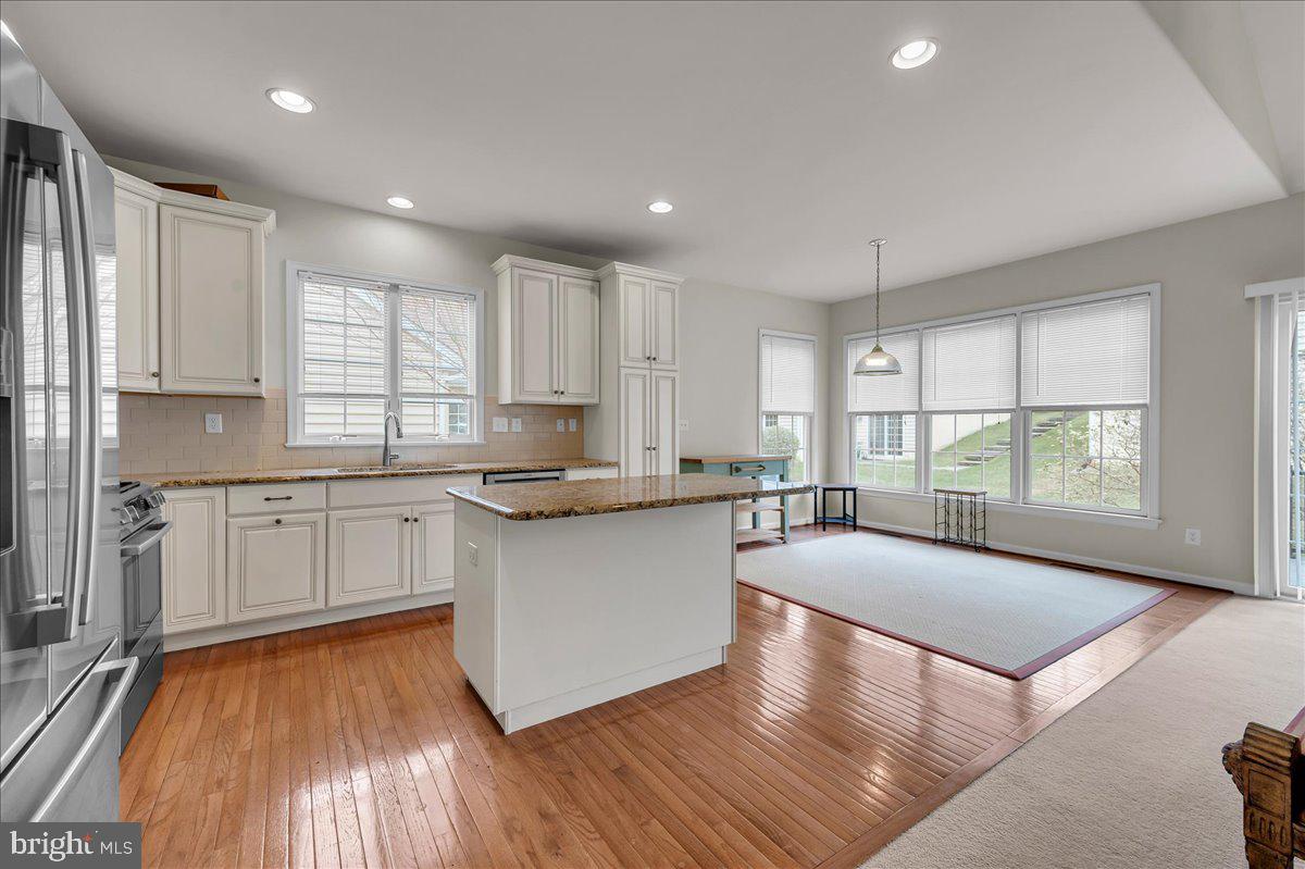 237 Crescent Road Landenberg, PA 19350 - Photo 23 of 46 a kitchen with stainless steel appliances granite countertop a stove a sink and white cabinets with wooden floor