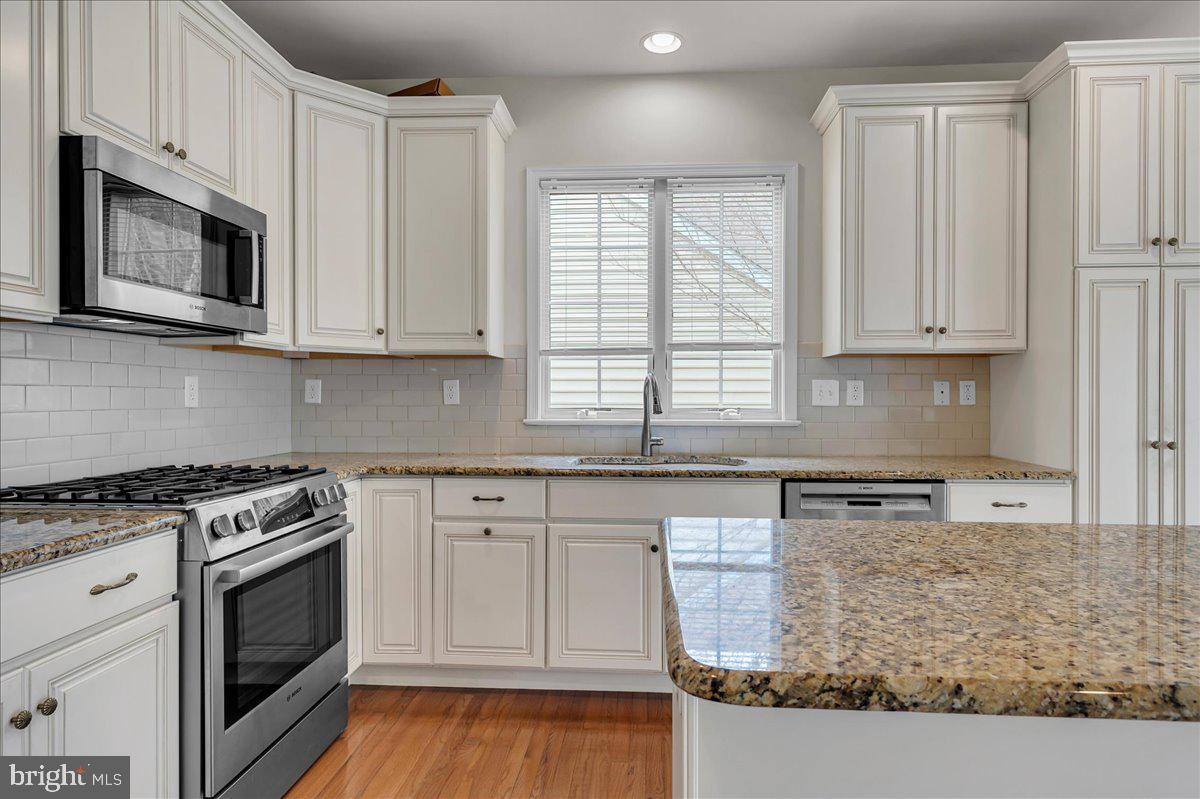 237 Crescent Road Landenberg, PA 19350 - Photo 24 of 46 a kitchen with stainless steel appliances granite countertop a stove a microwave and a white cabinets
