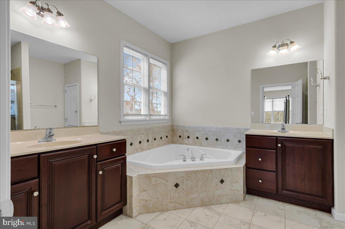 237 Crescent Road Landenberg, PA 19350 - Photo 28 of 46 a spacious bathroom with a tub double vanity sink and mirror