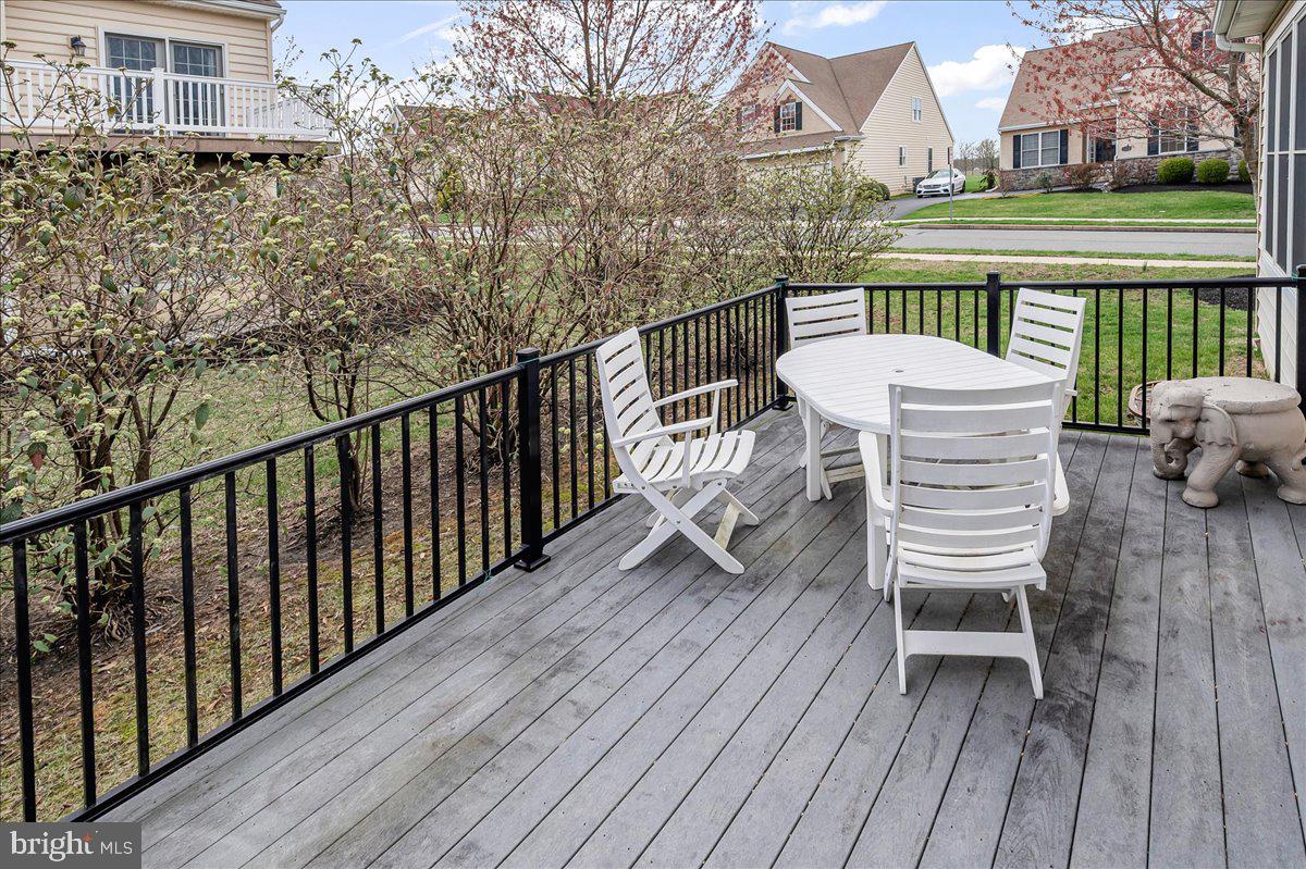 237 Crescent Road Landenberg, PA 19350 - Photo 42 of 46 a view of a deck with table and chairs and wooden floor