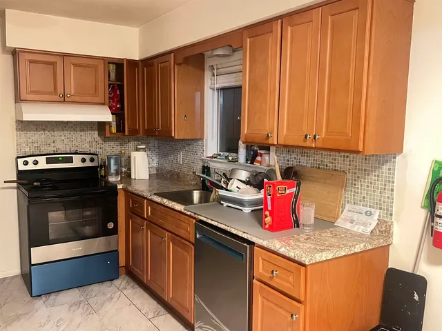 a kitchen with stainless steel appliances granite countertop a sink stove and cabinets