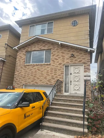 a view of a house with a large window and furniture
