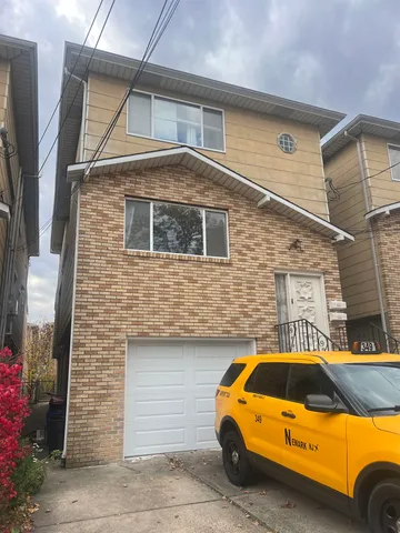 a front view of a house with parking space
