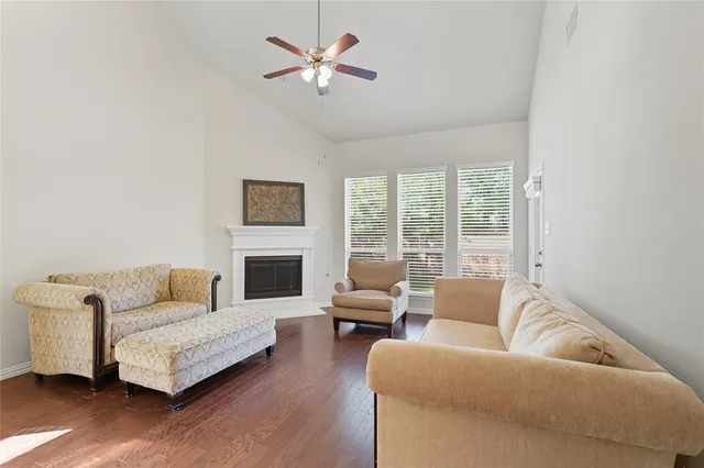 a kitchen with kitchen island a dining table chairs stainless steel appliances and cabinets