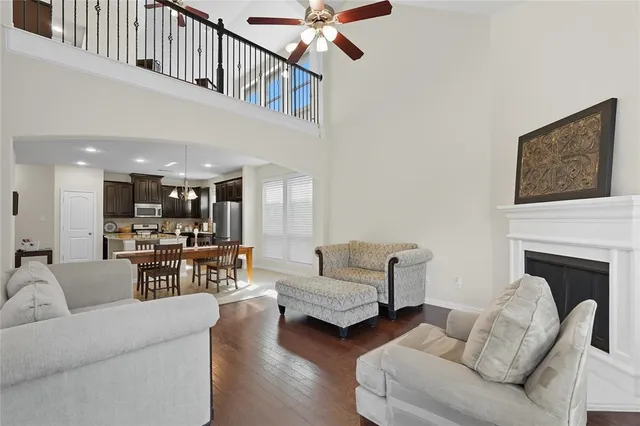 a living room with furniture fireplace and a large window