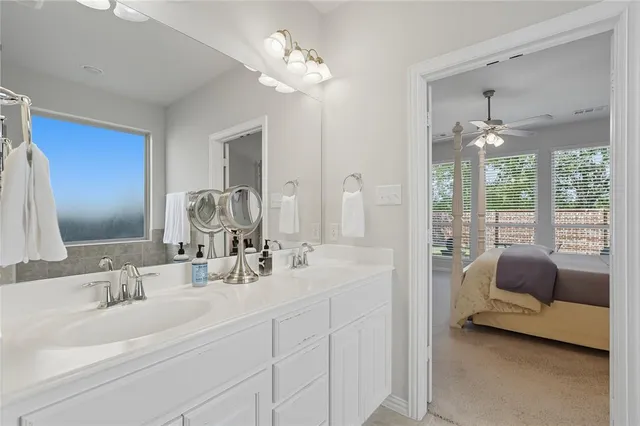 a bathroom with a tub sink and mirror