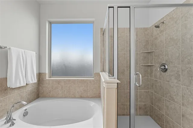 a en suite bathroom with double vanity and a mirror