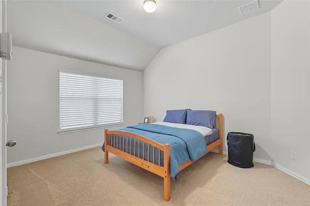 a bedroom with a bed and a night stand