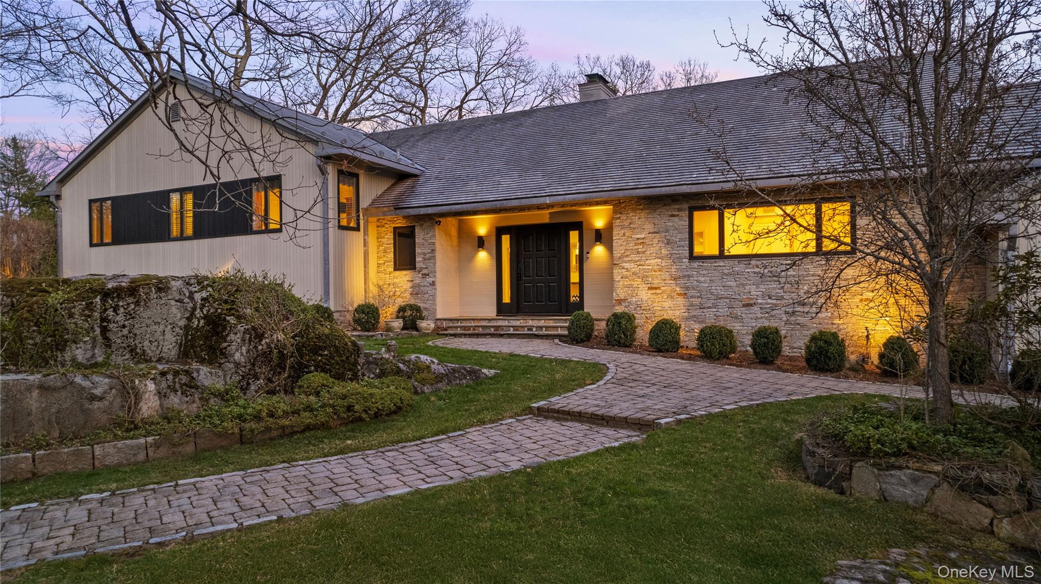 112 Woodlands Road Harrison, NY 10528 - Photo 1 of 43 a front view of a house with garden