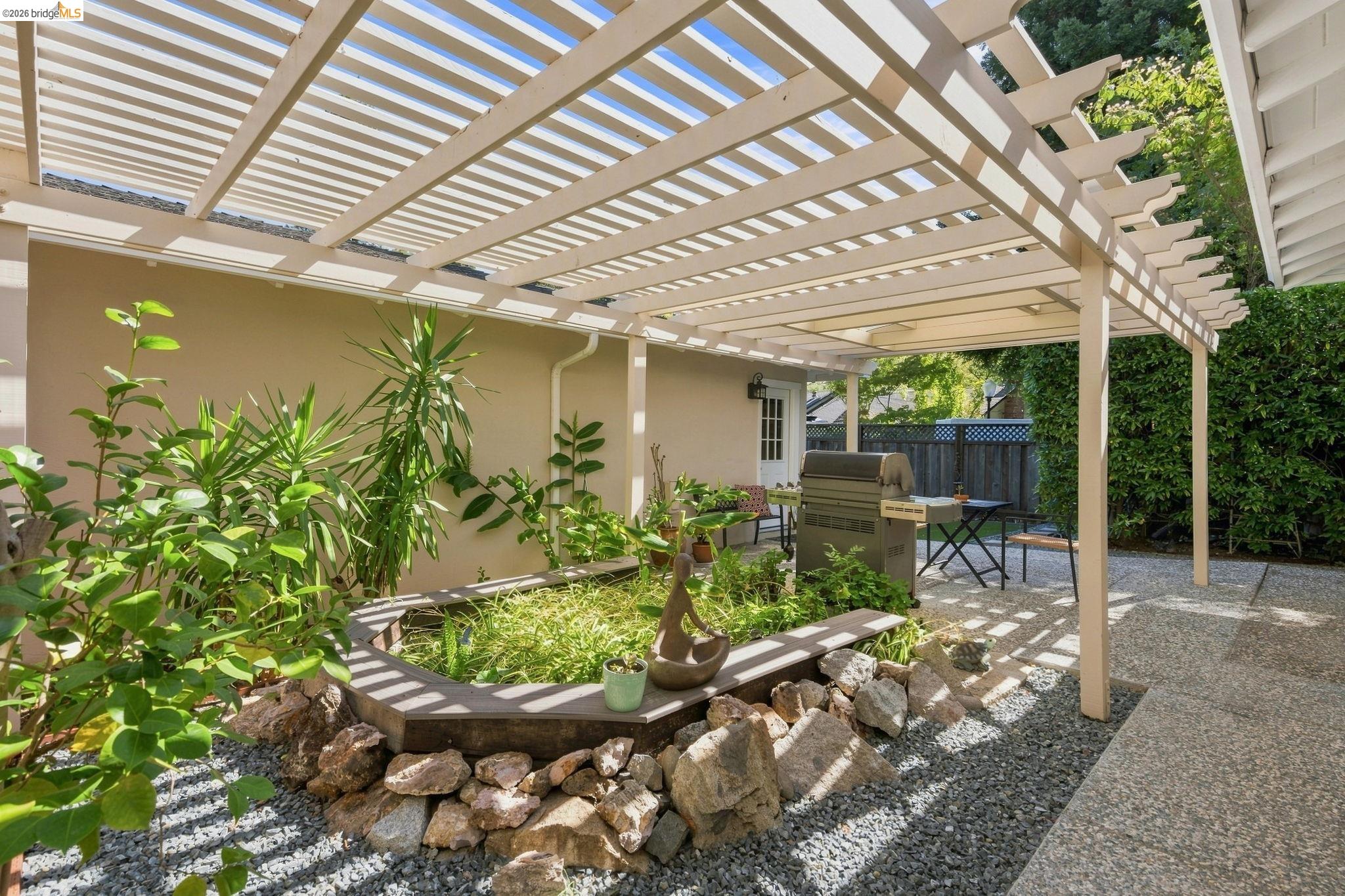 5075 Alhambra Valley Road Martinez, CA 94553 - Photo 43 of 68 Exterior pergola structure with a built-in planter and gravel landscaping