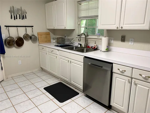 a kitchen with a sink and cabinets