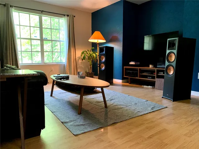 a living room with furniture a rug and a fireplace