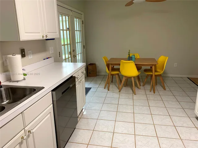 a kitchen with a sink cabinets and window
