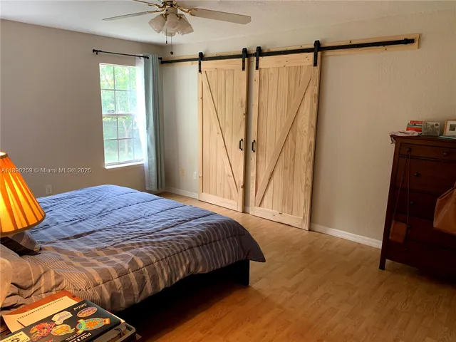 a bedroom with a bed window and a chandelier