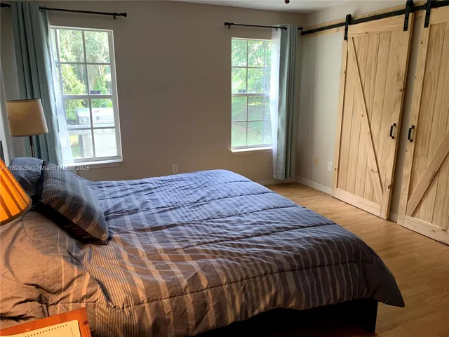 a bedroom with a bed window and a couch