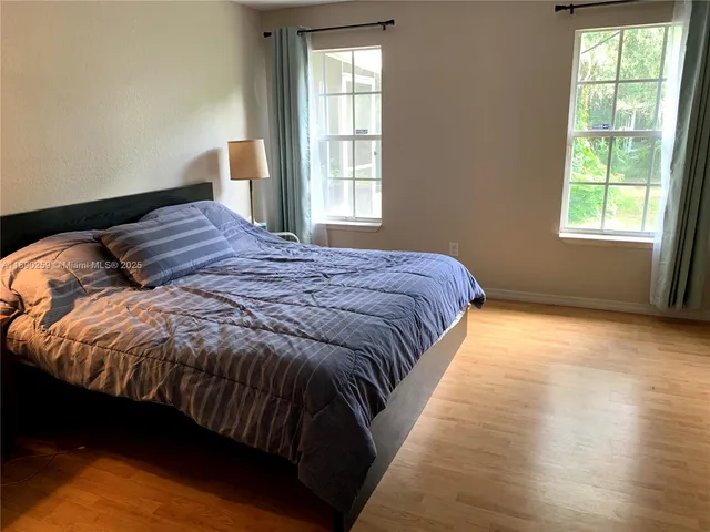 a bed sitting in a bedroom next to a window