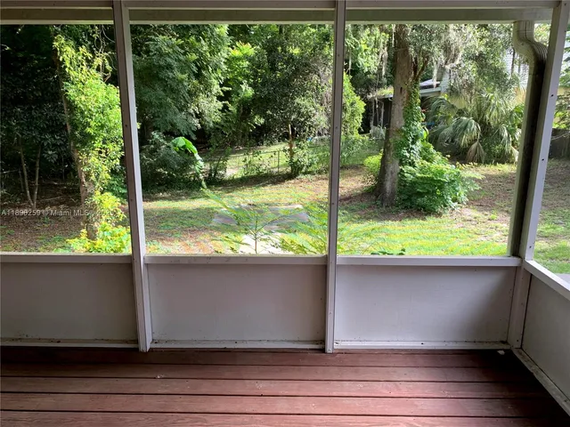 a sitting area with view of the back yard