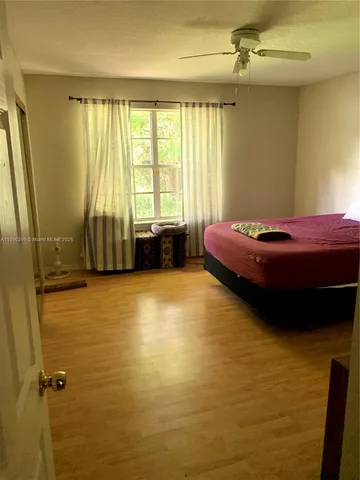 a room with a bed furniture and a window