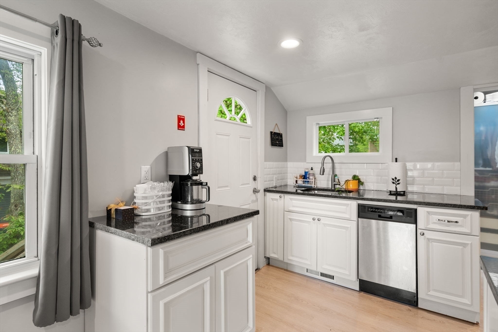 7 Indian Neck Road Wareham, MA 02571 - Photo 11 of 34 a kitchen with white cabinets and sink