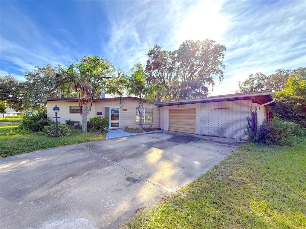 a view of a house with a yard and garage