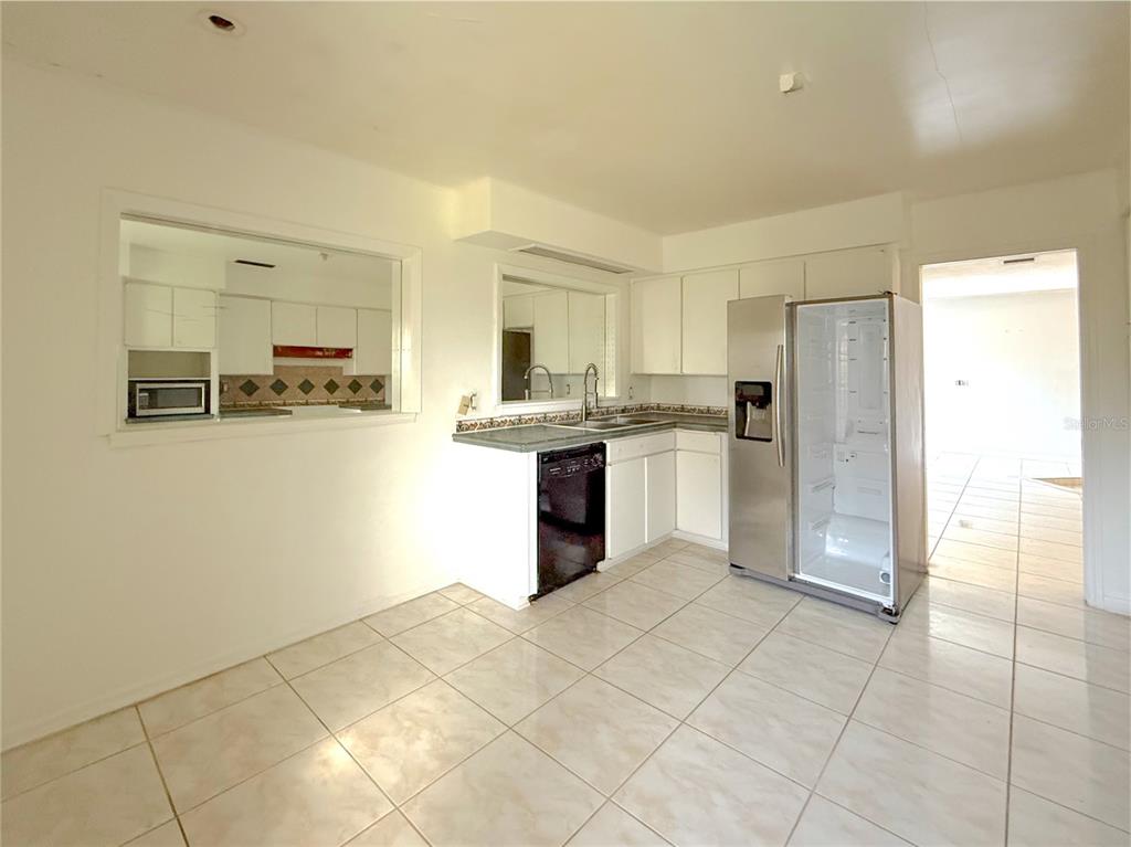 2464 Derbyshire Road Maitland, FL 32751 - Photo 17 of 42 a kitchen with stainless steel appliances granite countertop a refrigerator and a sink