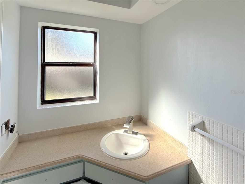 2464 Derbyshire Road Maitland, FL 32751 - Photo 29 of 42 a bathroom with a sink and a mirror