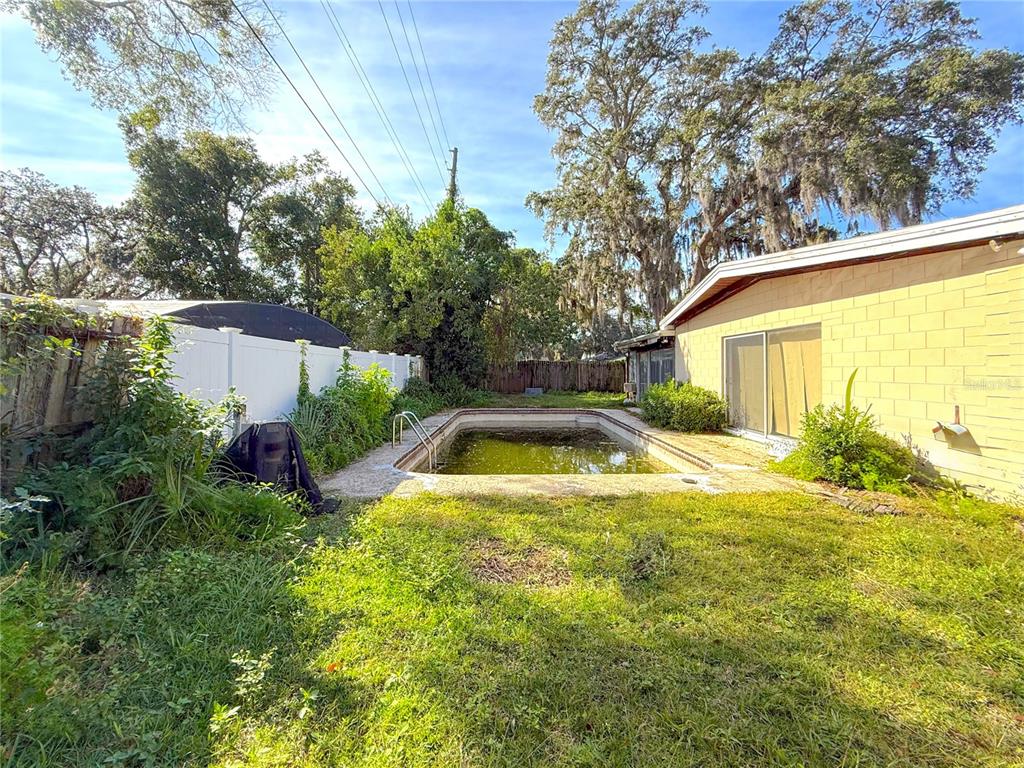 2464 Derbyshire Road Maitland, FL 32751 - Photo 31 of 42 a view of backyard with swimming pool and outdoor seating