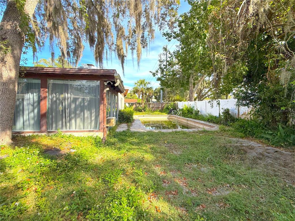 2464 Derbyshire Road Maitland, FL 32751 - Photo 33 of 42 a view of a wooden house with a big yard and large trees