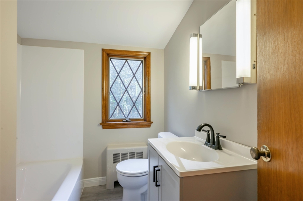 41 Marcus Road Wilmington, MA 01887 - Photo 20 of 29 a bathroom with a toilet sink and mirror