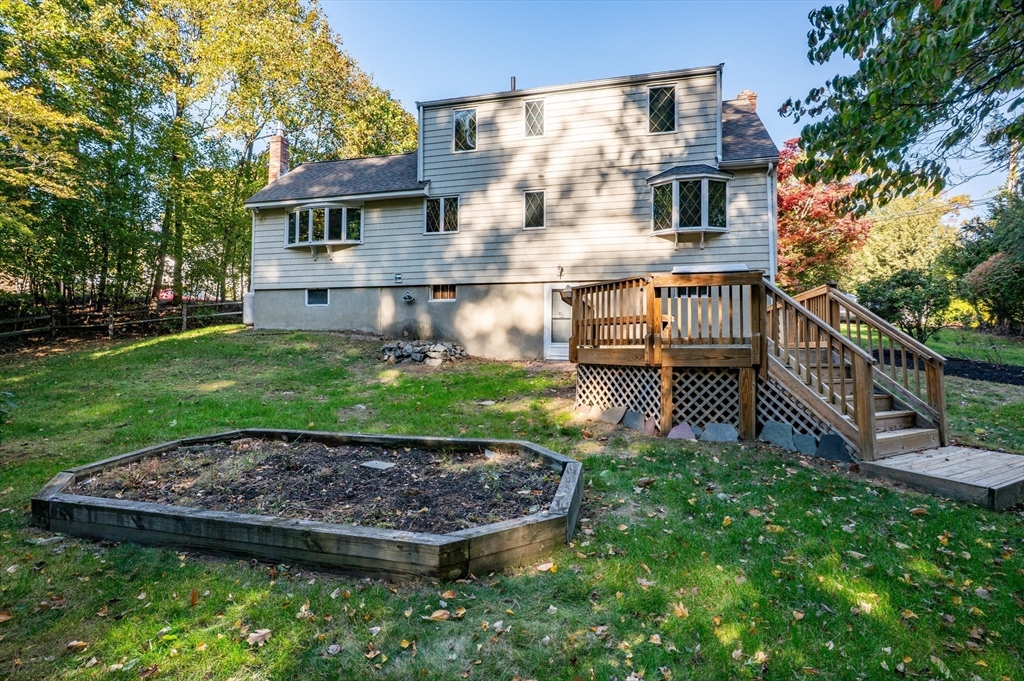 41 Marcus Road Wilmington, MA 01887 - Photo 3 of 29 a view of a house with a small yard and wooden fence