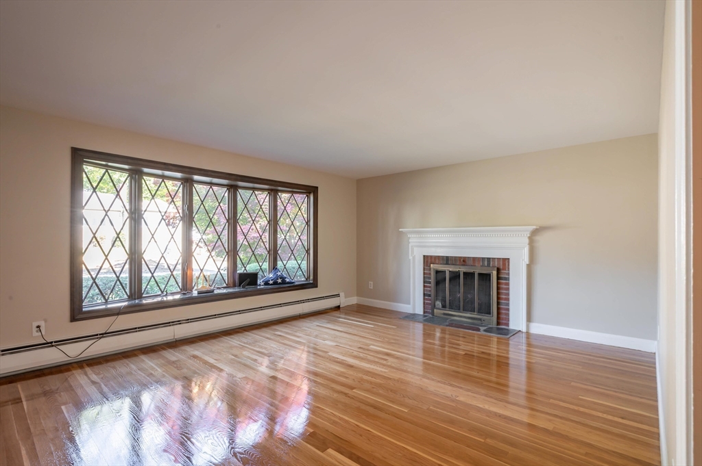 41 Marcus Road Wilmington, MA 01887 - Photo 5 of 29 wooden floor fireplace and windows in an empty room