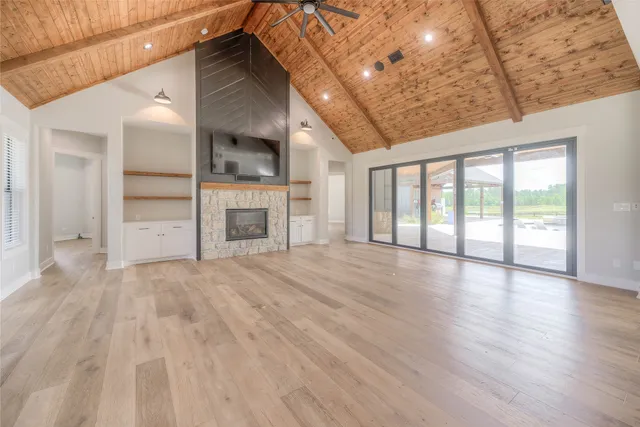 wooden floor in an empty room with a fireplace