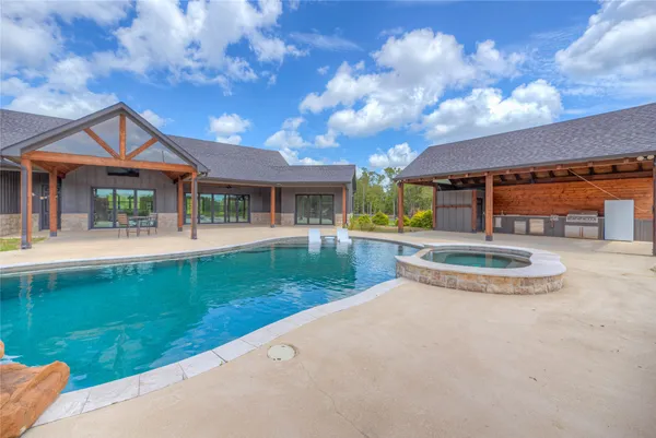 a view of a house with a yard porch and sitting area
