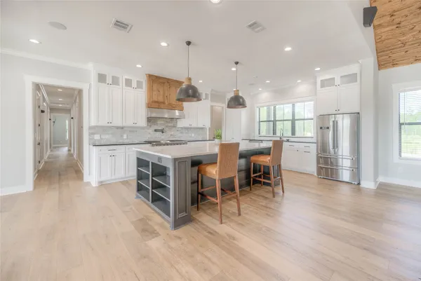 a large kitchen with a table and chairs