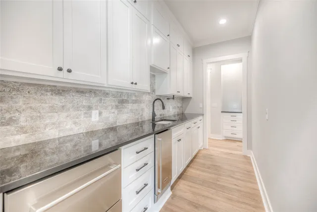a large kitchen with granite countertop a sink and dishwasher stove top oven